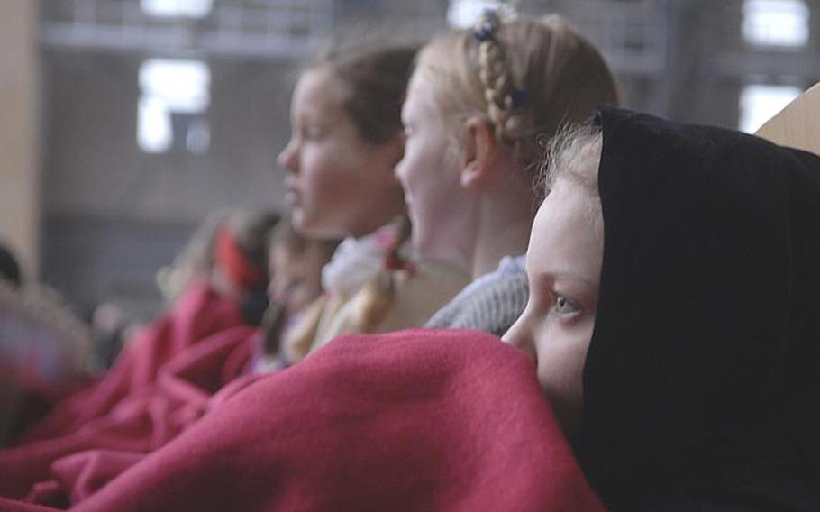 Oberammergau village girls bundle under blankets during a Roman Catholic Mass held on the Saturday morning before the 2010 premiere of the town's passion play on May 15. The auditorium is covered but the open-air stage lets in the elements, making it a good idea to dress warmly and take a blanket if attending the play, which ends at 10:30 p.m.