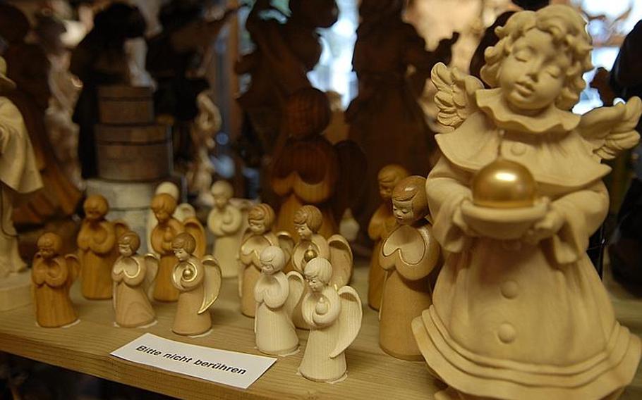 Angels carved from wood sit on a store shelf in Oberammergau. The Bavarian town is well known for its wood carvings, as well as its religious drama, the once-in-a-decade passion play.