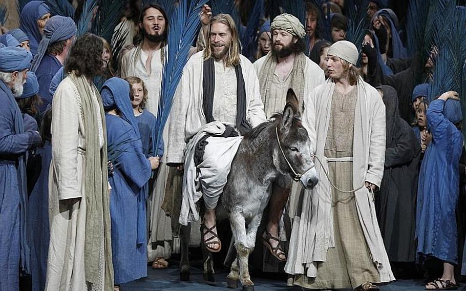 Andreas Richter portrays Jesus, center on donkey, during his Palm Sunday entry into Jerusalem during a dress rehearsal of the passion play.