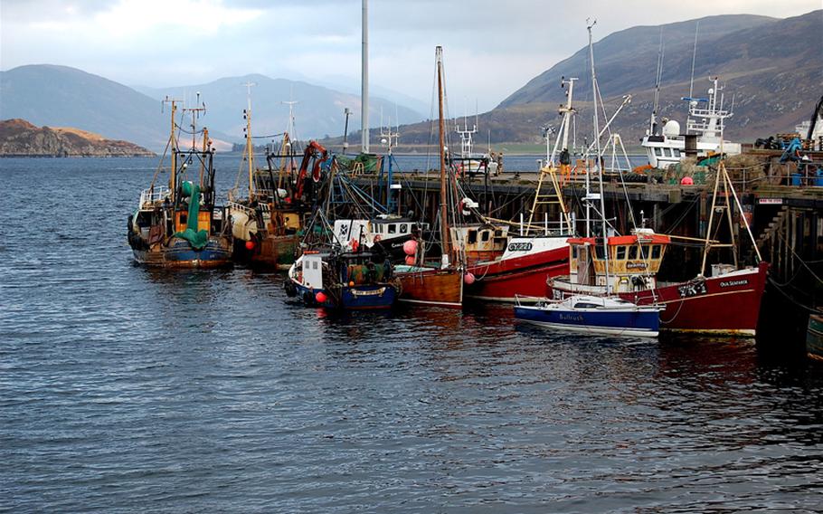Fishing boats huddle at the docks in Ullapool on Scotland's western coast. The quayside Shore Street is lined with shops, restaurants and bed-and-breakfasts.