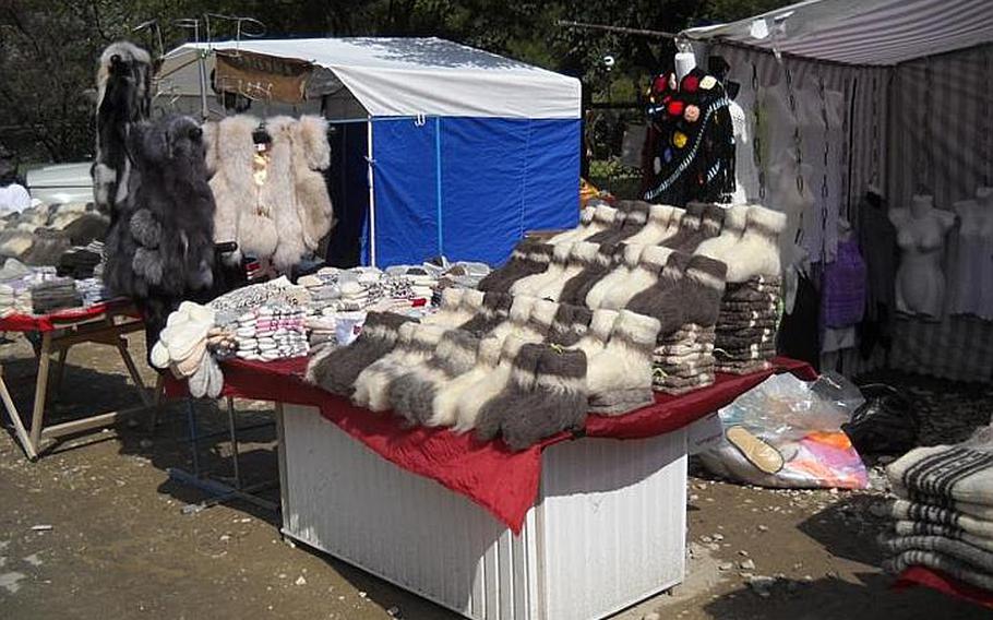 Knitted goods, fuzzy socks and fur vests are some of the unlikely offerings at a stand encountered en route to the beach of Praskaveevka, on Russia's  Black Sea coast.