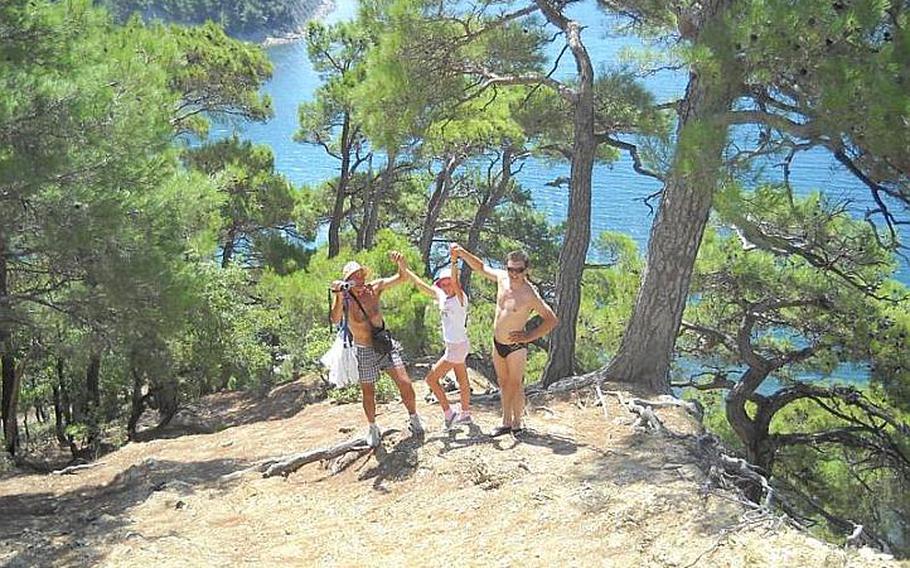 This unlikely trio of hikers, an actor from St. Petersburg, a budding gymnast from Vladimir, and a businessman from Moscow, celebrate having reached the end of a steep climb outside the beach of Dzhankhot, on Russia's Black Sea coast.