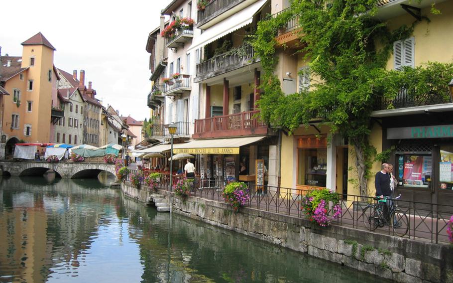 A peaceful, early-morning stroll along the canal in Annecy, France, allows visitors to enjoy the town's picturesque atmosphere before crowds of local residents and tourists converge on canal-side cafes.
