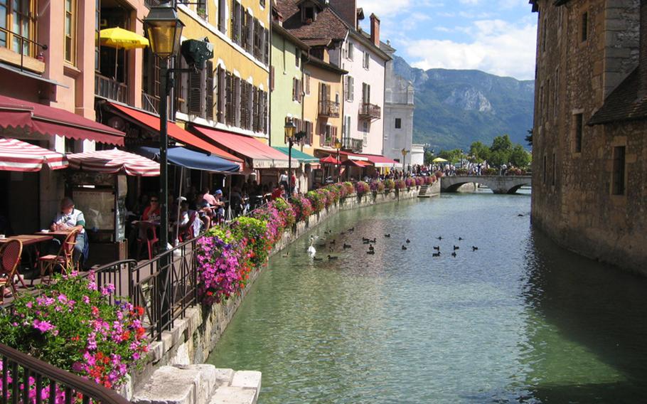 Annecy's canal-side cafes offer idyllic spots for peaceful contemplation, as well as the opportunity to toss bits of food to swans and ducks paddling by.