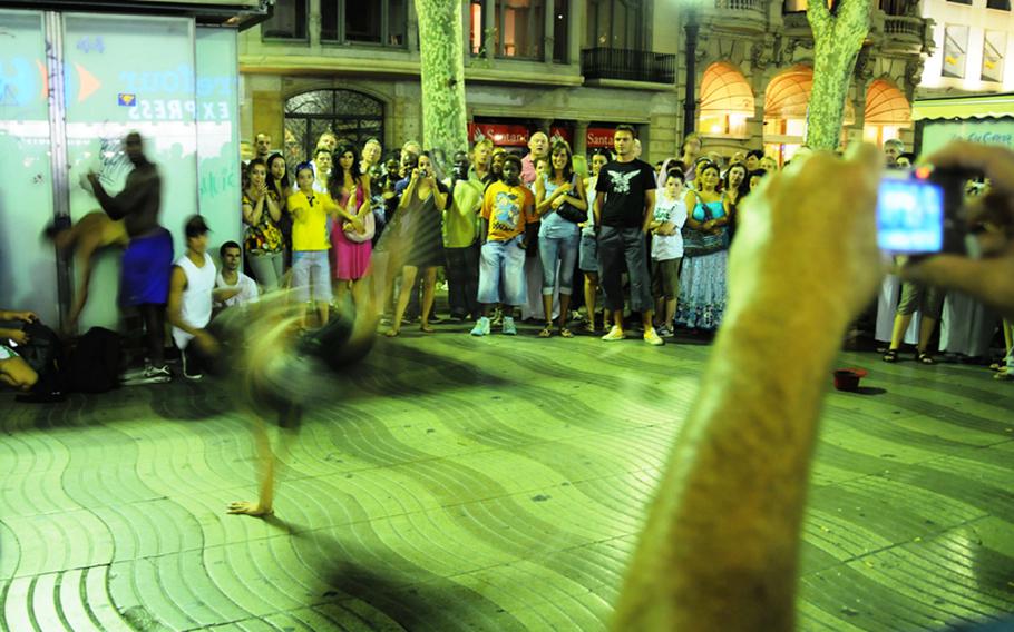 Street performers busk on Las Ramblas, one of the main attractions of walking down Barcelona’s main street. 