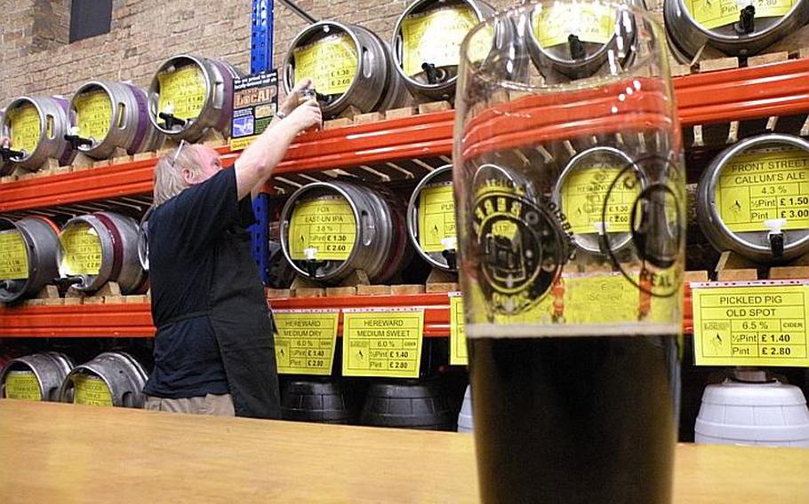 A bartender pulls a half pint from a cask at the second annual Elysian Winter Beer Festival in Ely, England. Patrons at the two-day festival, which concludes Saturday, could sample more than 50 ales by the pint or half pint.