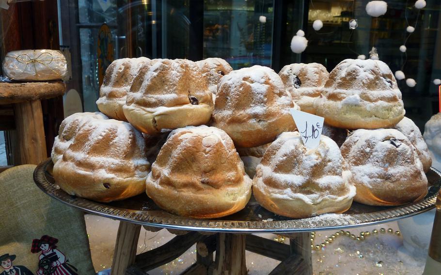 A stack of miniature Kouglehopf, also known as Gugelhupf or Kugelhopf, a popular Alsatian cake, sit in the window of a Wissembourg bakery.