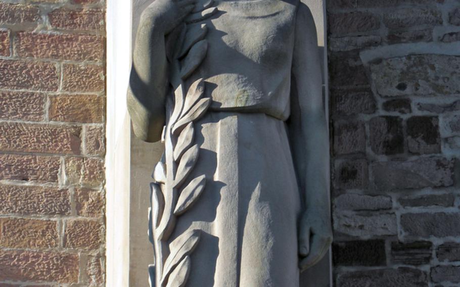 The figure of a woman holding an olive branch decorates a monument to the fallen in an Alsatian town. With its proximity to the German border, the region has been fought over many times throughout the centuries.