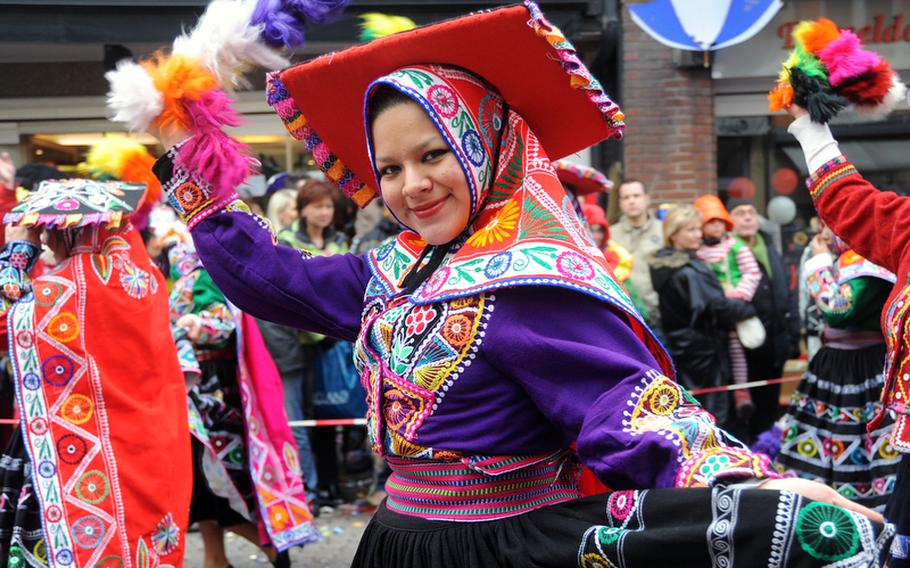 A participant gives the Düsseldorf, Germany, Rose Monday Karneval parade a South American flavor .