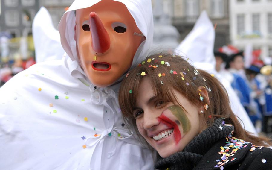 A Blanc Moussi poses with a spectator during the Laetare Sunday parade in Stavelot, Belgium. Unlike most European pre-Lent carnival celebrations, this one takes place toward the end of Lent.