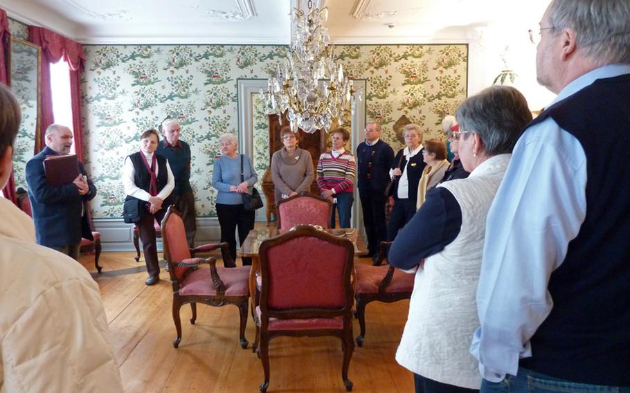 Visitors to the Goethe-Haus in Frankfurt listen to their guide as he talks about the Peking Room, the largest room on the first floor. The room got its name from the wallpaper design.