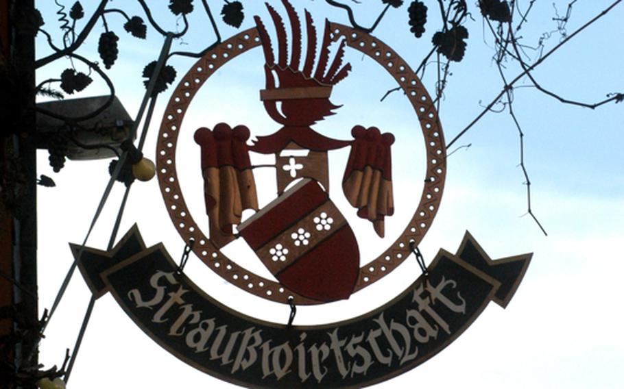 An elaborate sign advertises a local wine tavern where a vintner can sell his own wines. Along the Weinstrasse, these inns are known as Strausswirtschaften.