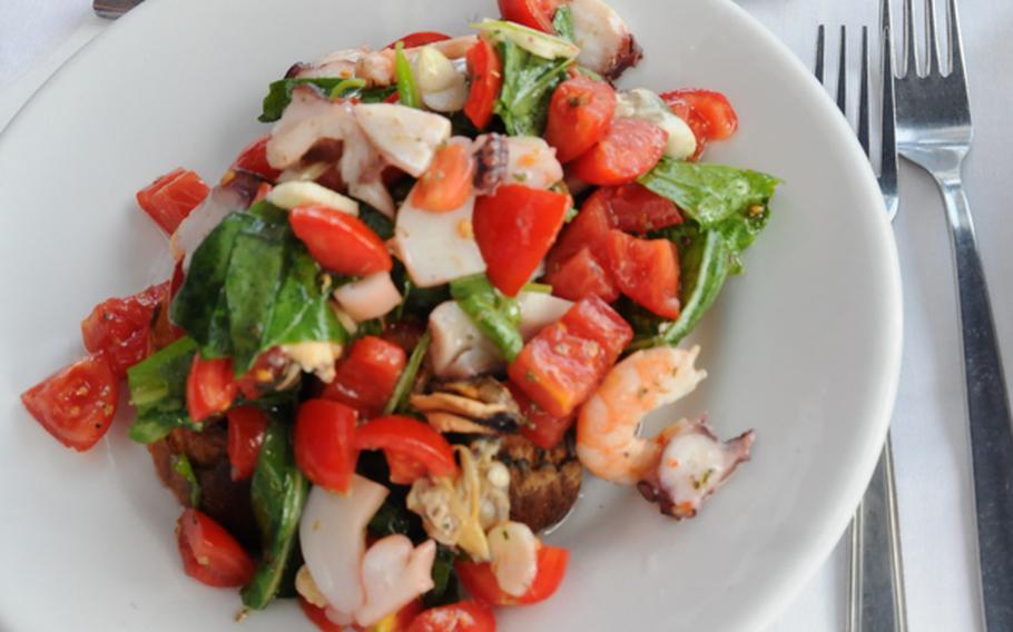 Fresh mussels, clams, tomatoes, basil and garlic top lightly toasted bread for a mouthwatering appetizer at Chalet Primavera on Ischia, known for its fresh shellfish and other seafood.