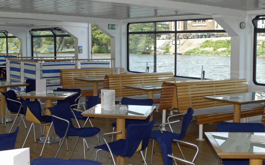 On a warm spring day, the indoor seats of the Primus-Linie cruiser Nautilus remain empty as the ship cruises the Main River in Frankfurt.