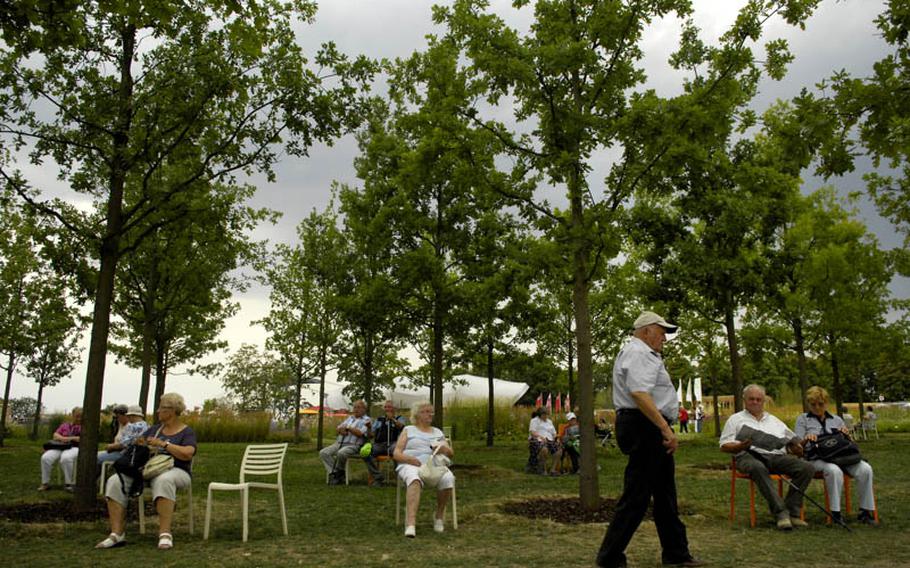 Visitors to the horticulture show in Koblenz, Germany, rest their feet under a few trees at the Ehrenbreitstein fortress.