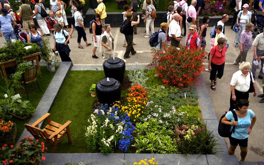 Visitors stroll through one of two flower halls displaying a colorful variety of plants and flowers at this year&#39;s federal horticulture show in Koblenz, Germany. The show continues through mid-October.