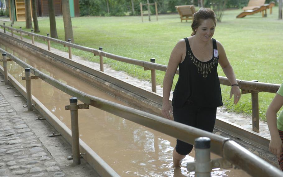 A visitor to the barefoot park trudges through the mud basin. The clay-rich mud is supposed to be good for the skin.