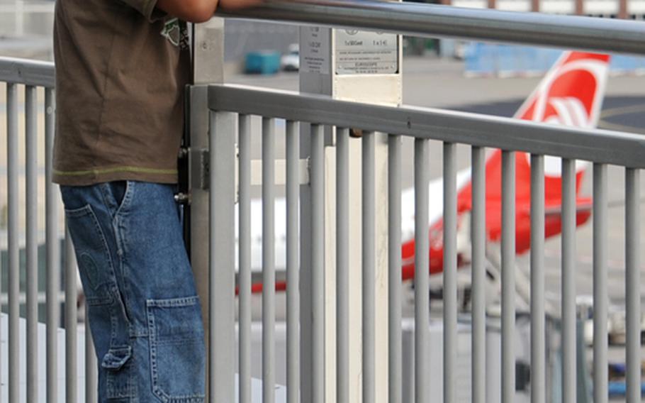 A youngster tries to get a closer look at the busy flight line at Frankfurt Airport.