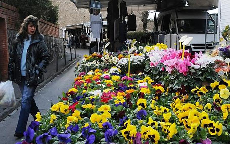 Fresh flowers are some of the many goods for sale during the weekend outdoor market in the heart of Montalcino, in the hills of Italy's Tuscany region.