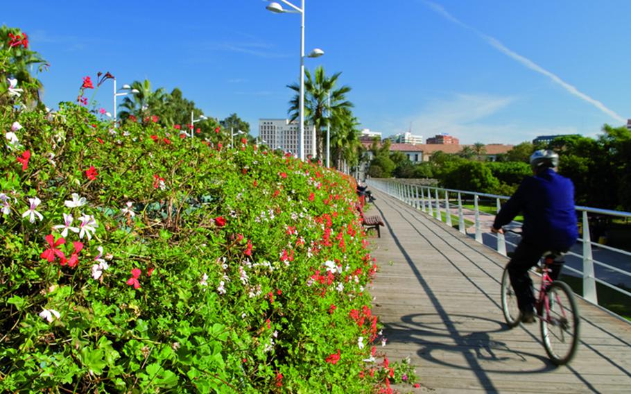 Turia Gardens' colorful flowers, palm trees and other greenery make up a rich oasis for bicycle riders and walkers right in the middle of Valencia, Spain.