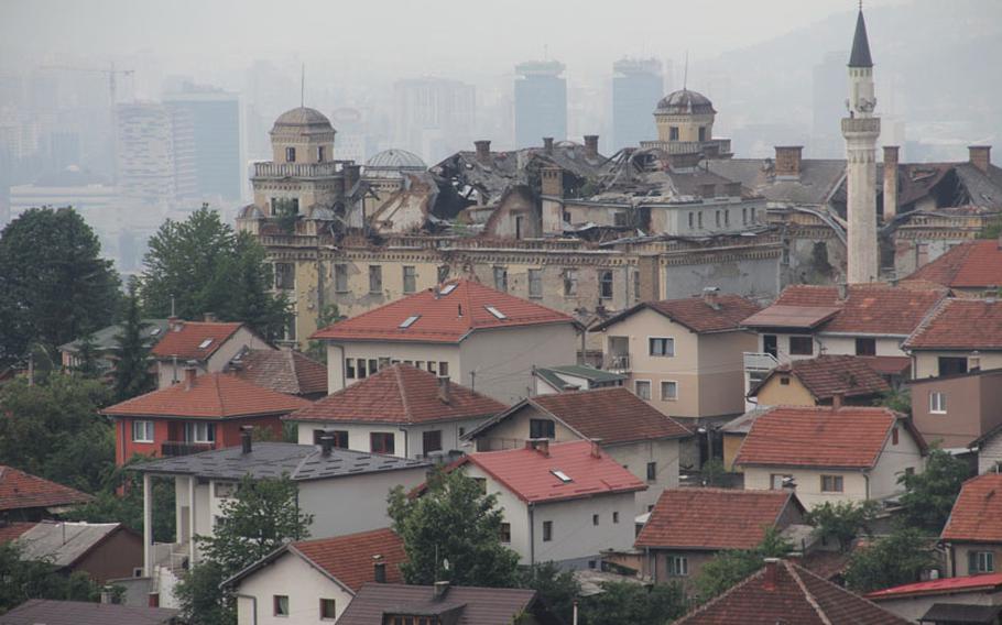 A building dating from the Hapsburg Empire still sits heavily damaged from the 1990s Bosnian war. Evidence of the war dots the city, with many buildings still bearing scars from bullets and mortar rounds.