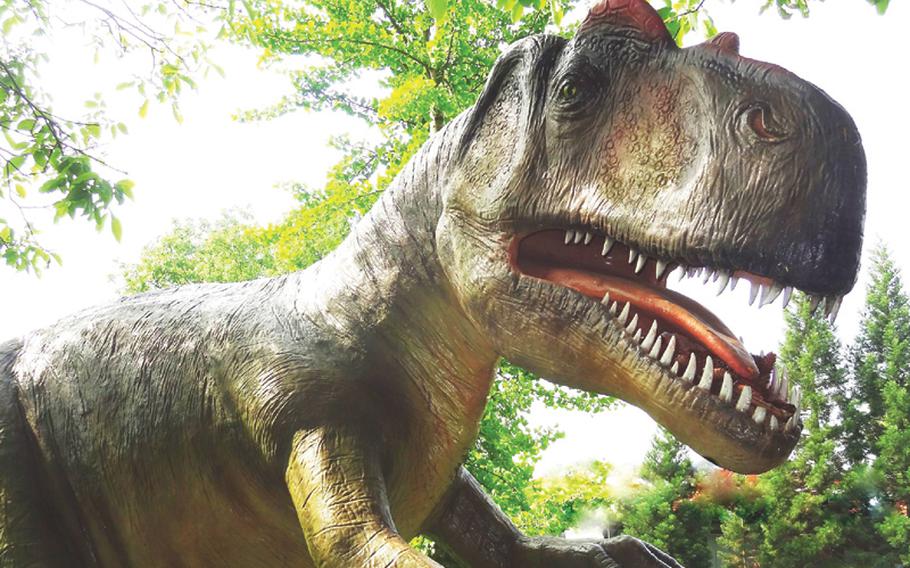 At the Dino Park outside the Urwelt-Museum in Holzmaden, Germany, life-size dinosaur statues like this one of an Allosaurus will delight children.