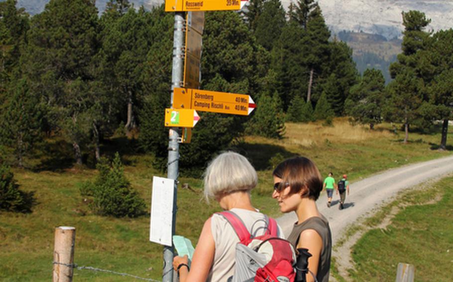 Hikers get their bearings before setting out on a trail. Hiking among the country's majestic peaks is a national pastime in Switzerland.