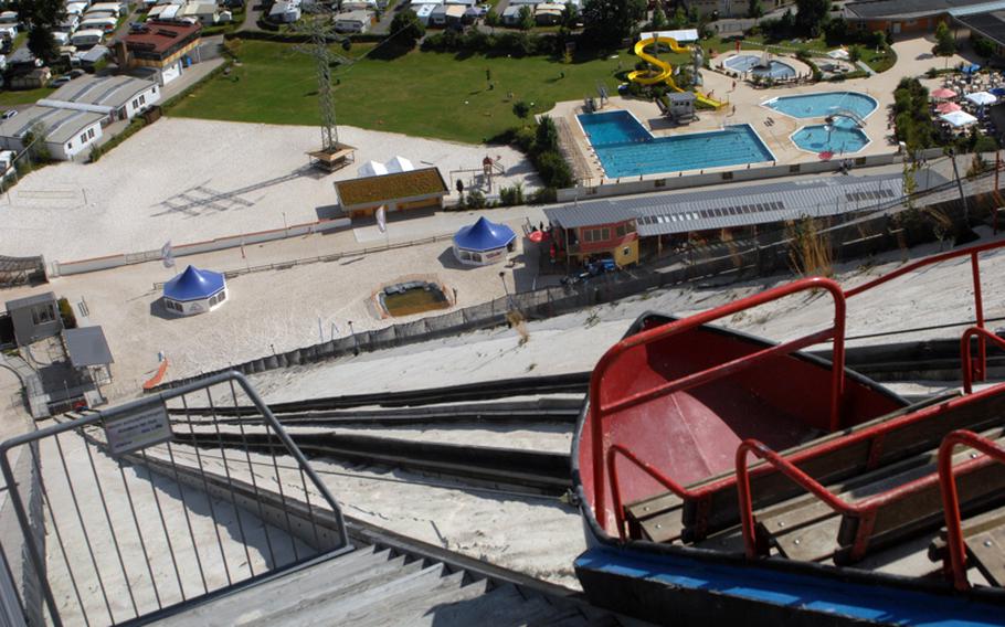 A lift car overlooks the swimming area from the top of Monte Kaolino, the roughly 400-foot sand hill formed during decades of mining in Hirschau, Germany. Now an amusement park with swimming pools and a handbrake coaster, Monte Kaolino draws crowds of locals and Americans on summer days.