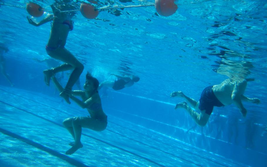 Children and adults swim in one of the pools at Monte Kaolino, an amusement park in Hirschau, Germany, in the Grafenw?hr and Vilseck area. Built around a roughly 400-foot-high heap of sand left over from decades of mining in the area, the park is a popular draw on summer days.