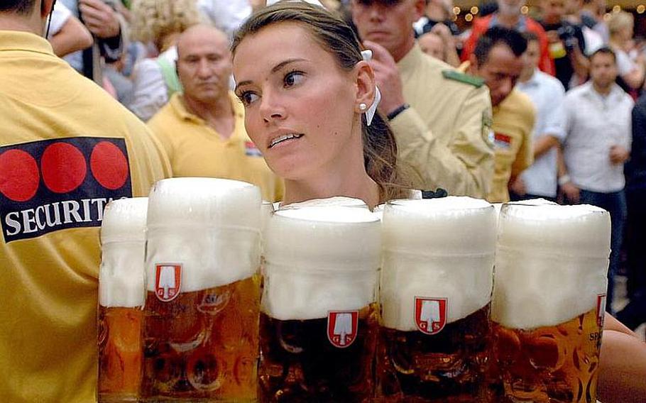 A waitress delivers liter mugs of beer in the Schottenhamel Festhalle on the first day of Oktoberfest 2011. In years past, revelers have consumed 7.9 million liters of beer.