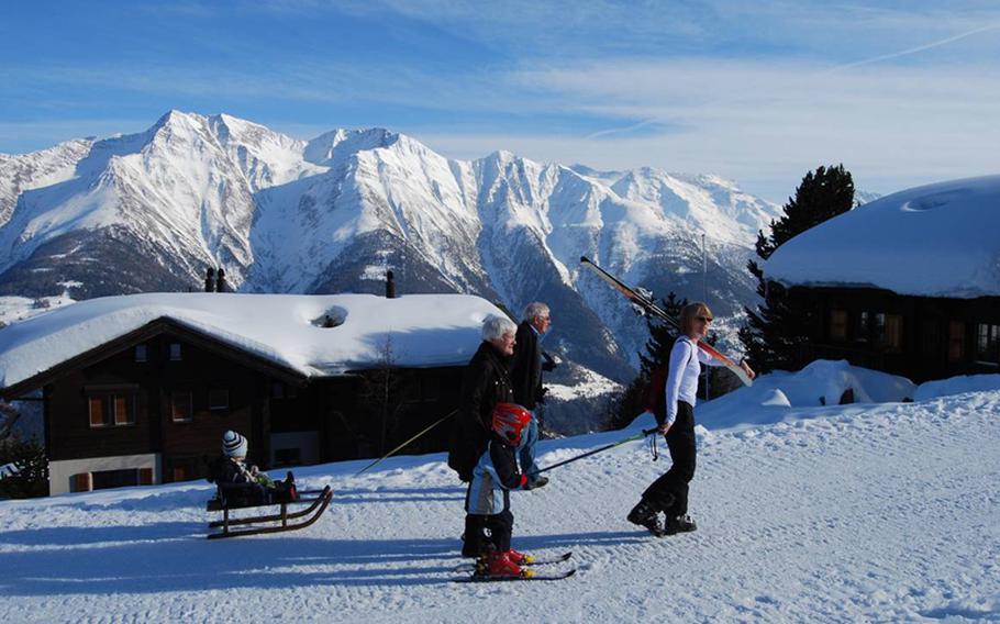 A family navigates the tiny Swiss village of Riederalp on foot. The village has no cars, but it's  easy to walk on groomed tracks. High above the village and overlooking the Aletsch glacier are more trails specifically for walking.  Non-skiiers can purchase a ticket to ride the gondola up, then walk back to the village.  