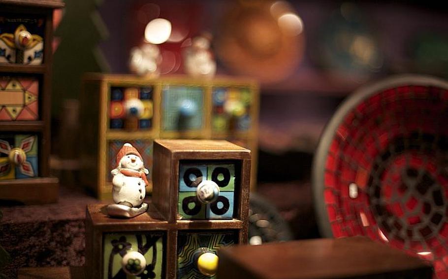 Hand-painted toys, colored glass and decorative ceramics brighten a display at Bonn's Christmas market.