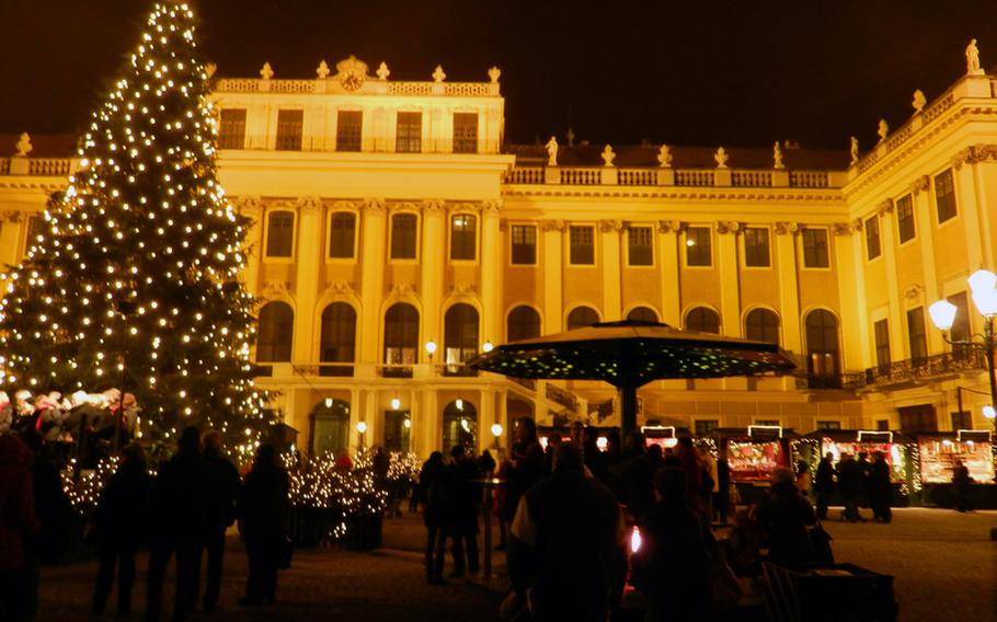 Schönbrunn palace in Vienna, Austria, provides a cultured backdrop for one of the city's Christmas markets. The market is most magical in the evening, when the palace is alight and a tall tree twinkles.