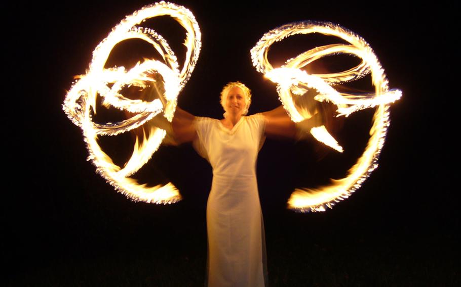 A "fire angel" performs with torches at the Johanniskreuz Romantische Waldweihnacht. The fire show this year takes place at 7 p.m. Dec. 15.