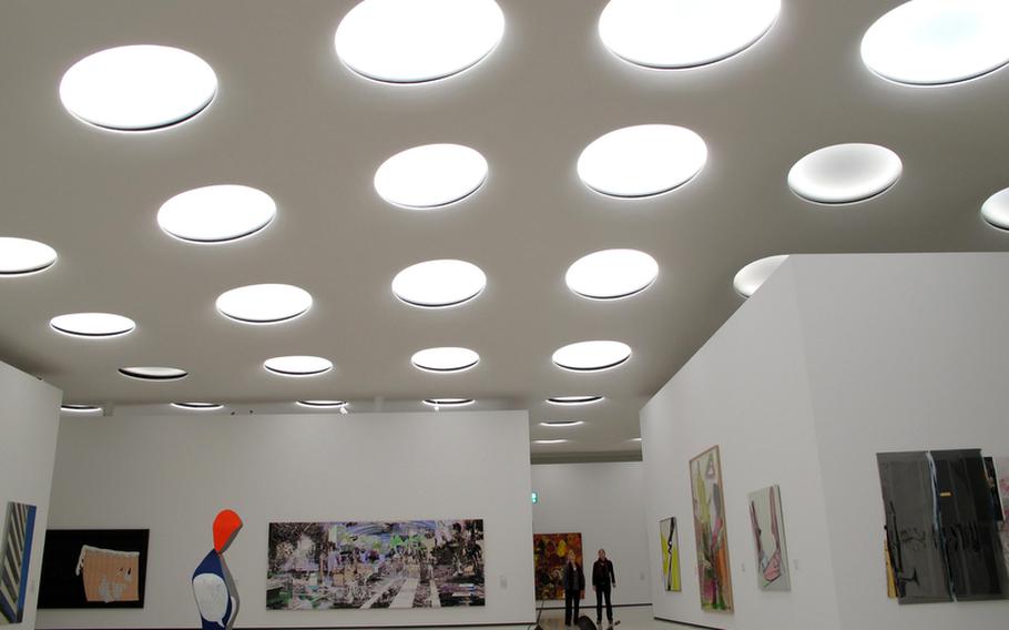 Visitors gaze at the overhead windows that shed light on the subterranean hall housing the contemporary art collection at the Städel Museum in Frankfurt, Germany.