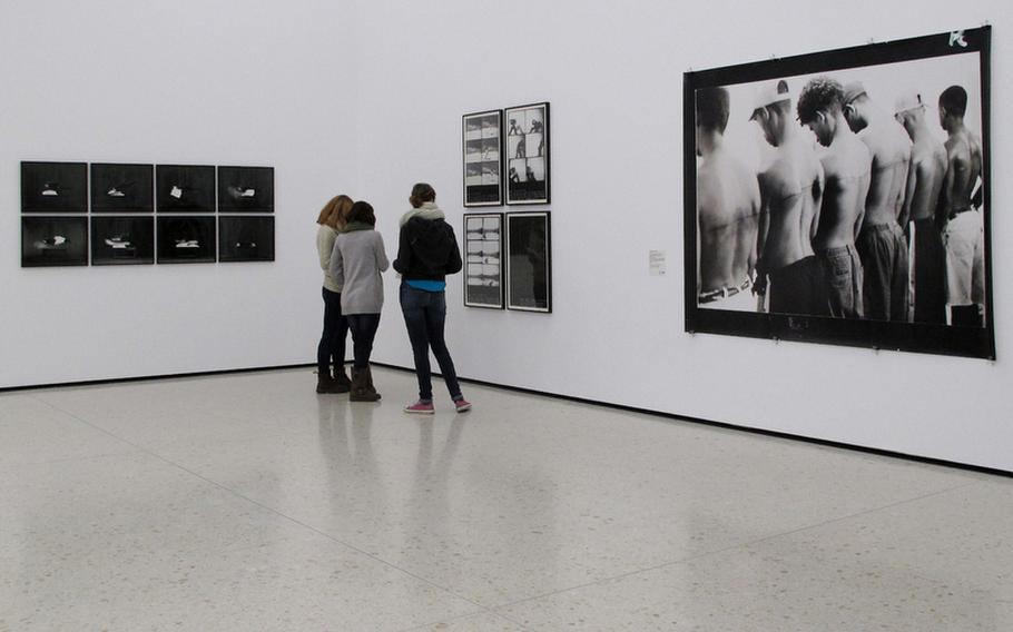 Visitors to the Städel's contemporary art collection in Frankfurt, Germany, view photographs on display.