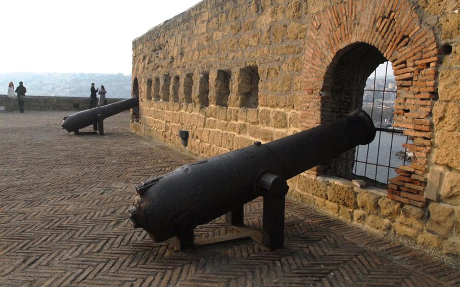 Cannons pointing toward the city of Naples, Italy, line the roof of Castel dell'Ovo.