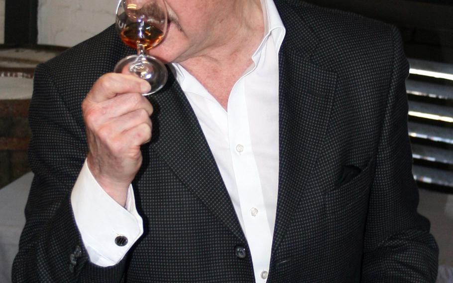 Master blender Richard 'The Nose' Paterson sniffs a glass of whisky before tasting it at the Jura Distillery on the Isle of Jura, off Scotland's west coast. Lingering inhalations are all part of whisky-tasting etiquette.