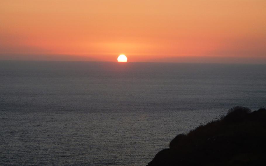 Sunset seen from the terrace of a "dammuso," the island's characteristic lava stone homes, rented just outside the town of Scauri, a hamlet on Pantelleria.