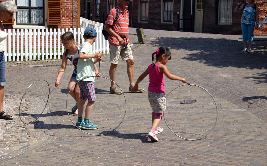 Children learn how to roll hoops, just like kids did a century ago, during a visit to the Zuiderzee Museum in Enkhuizen, Netherlands.