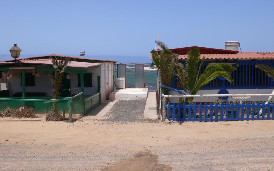 Beach houses such as these in the remote fishing village of Majanicho, on the island of Fuerteventura in the Canary Islands, have a perfect view of sand and sea.