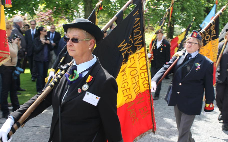 Belgian patriots march into the Flanders Field American Cemetery in Waregem, Belgium, during the Memorial Day ceremony on May 26, 2013.