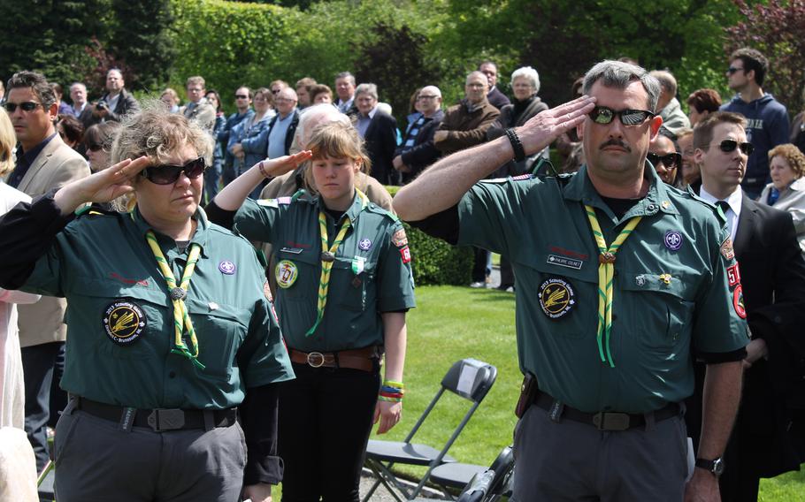 Carine Van de Velde, left, Darline Colinet and Philippe Colinet, all from Boy Scouts Venturing Crew 511 from the Charlemagne District in Belgium, volunteer at this year???s Memorial Day service at Flanders Field American Cemetery.
