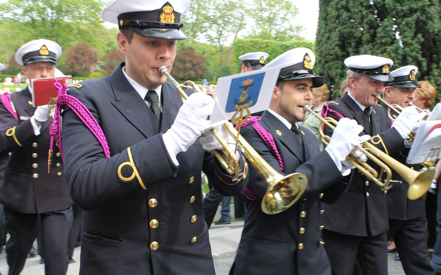 The Royal Band of the Belgian navy leaves the Flanders Field American Cemetery in in Waregem, Belgium, with a final song after the Memorial Day service.