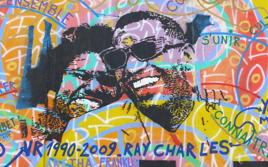 Not all of the artwork on the gallery is political — some is just colorful. Here, American music legends Ray Charles and Aretha Franklin are depicted.