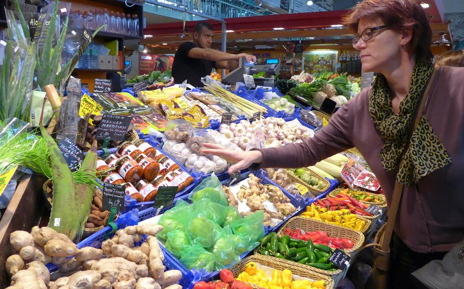 A customer inspects the goods at the Kleinmarkthalle in Frankfurt, Germany.