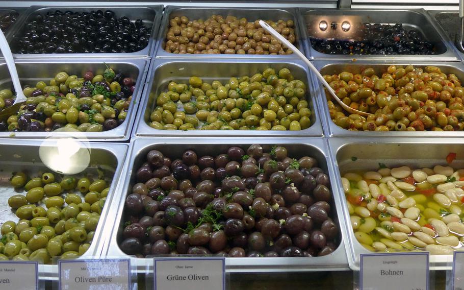 A stand specializing in Middle Eastern food offers various types of olives.