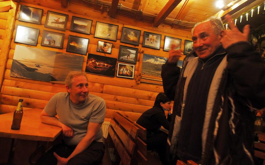 A longtime resident of Brezovica, Kosovo, spins a yarn at one of the bars that remained open even though the ski lifts have been closed for a year.