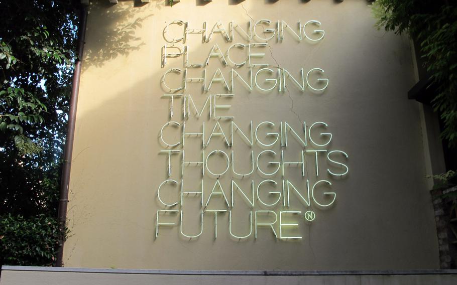 A neon-tube work made in 2003 by Maurizio Nannucci stands in the Peggy Guggenheim Collection sculpture garden in Venice .