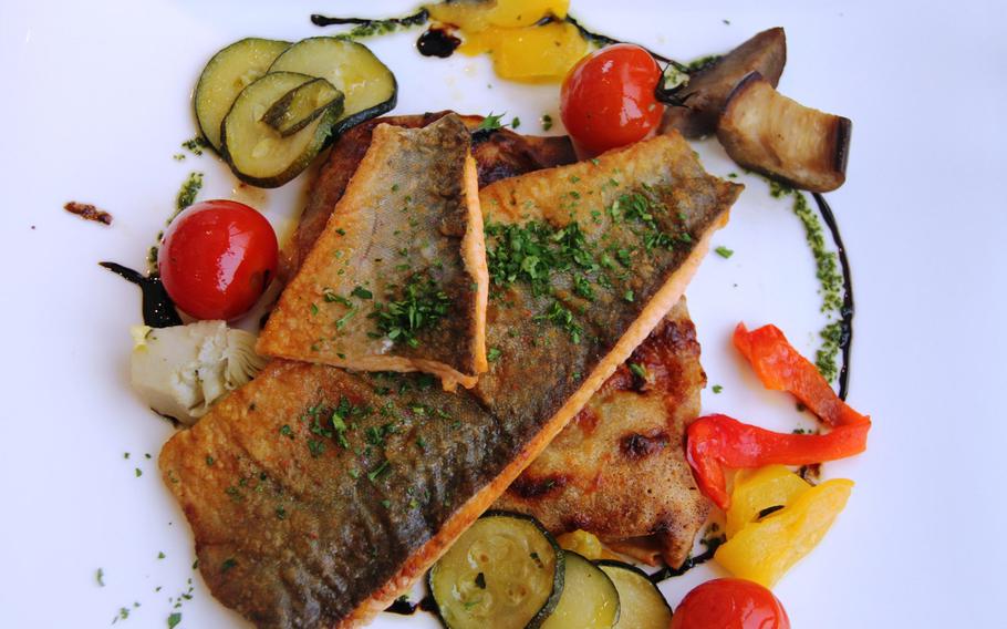 Think of cheese and chocolate when you think of Swiss foods? Think again; fish is a popular Swiss food. Pictured is saibling (brook trout) with a ratatouille crepe.